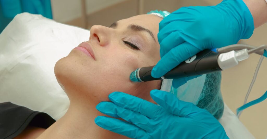 A woman receiving a facial skincare treatment with a specialized device wearing protective gloves.